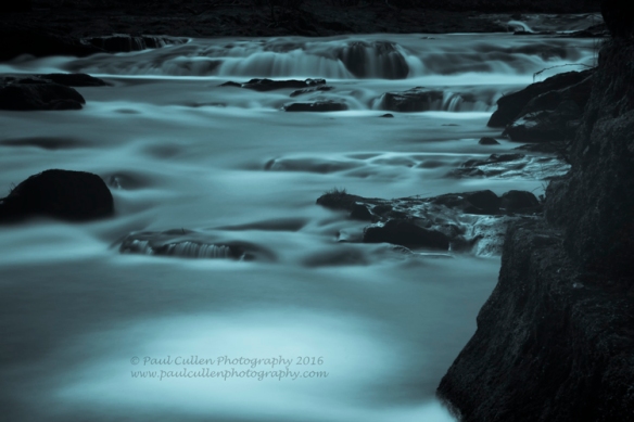 Abstract river flow - water taking on a milky form through long exposure.